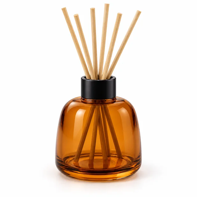 100ml Amber Rounded Shoulder Glass Reed Diffuser Bottle — transparent amber; black open diffuser collar and rattan reeds